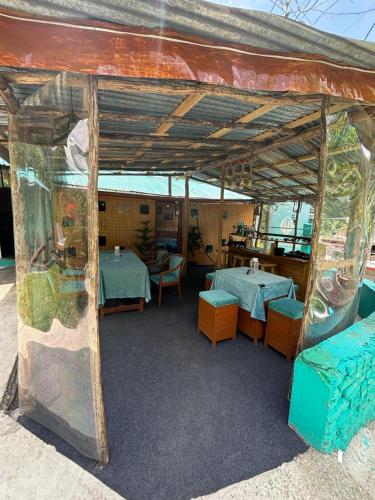 a patio with two tables and chairs in a building at Beholden Stay and Cafe - A Luxury Boutique Hotel in Manali in Manāli