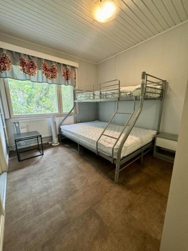 a bedroom with two bunk beds and a window at Himos Hannula in Jämsä