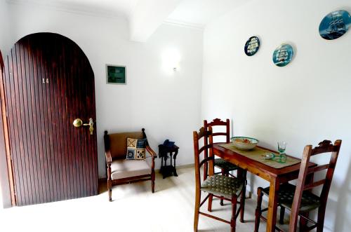 a dining room with a table and chairs and a door at Golden Apartments in Agios Nikolaos