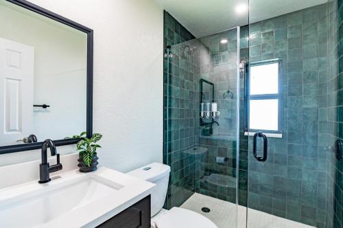 a bathroom with a sink and a glass shower at 400 South in Cocoa Beach