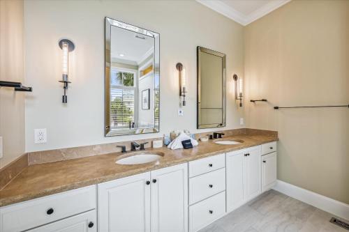 a bathroom with two sinks and a large mirror at 4 Collier Beach Rd- Oceanfront, Private Pool, Elevator, FREE Activities Included in Hilton Head Island