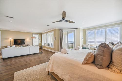 a bedroom with a large bed and a living room at 4 Collier Beach Rd- Oceanfront, Private Pool, Elevator, FREE Activities Included in Hilton Head Island