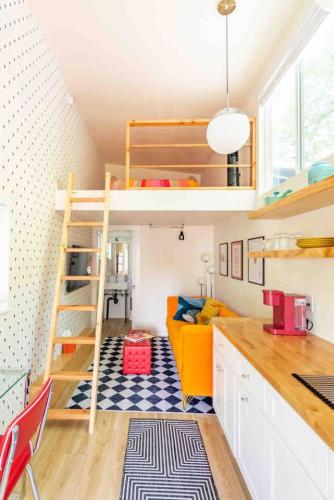 a small room with a bunk bed and a kitchen at Unique Vintage Vibes - Cozy Tiny Home close to UT in Austin