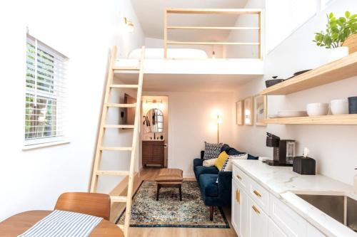 a living room and kitchen with a loft bed at Cozy and Bright Mid-Century Gem in Eastside Action in Austin