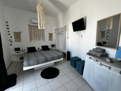 a bedroom with a bed and a tv in it at Eris Studios in Adamas
