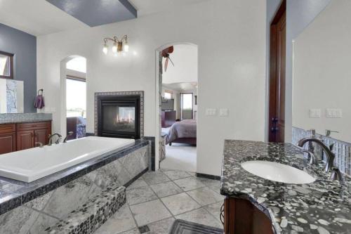 a large bathroom with a tub and a sink at Luxury Mansion Retreat Sleeps 20 Panoramic VIEWS in Castle Rock