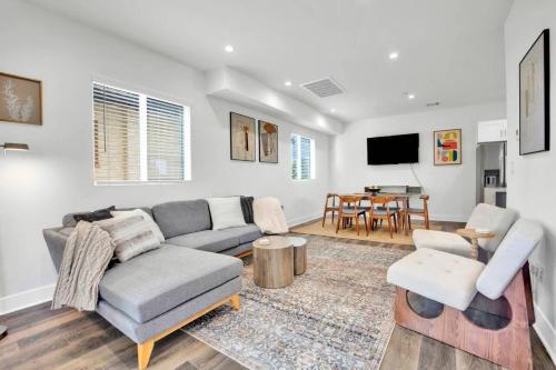 a living room with a couch and a table at Luxe Townhouse Near Downtown LA in Los Angeles