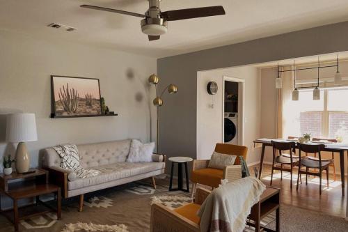 a living room with a couch and a table at McKinley House Prime - Pool, Patio and Garage in Amarillo