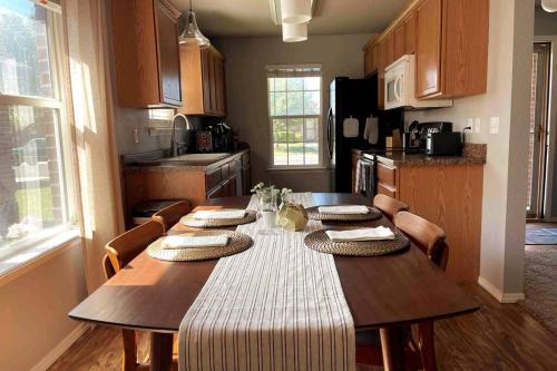 a kitchen with a table with chairs and a dining room at McKinley House Prime - Pool, Patio and Garage in Amarillo