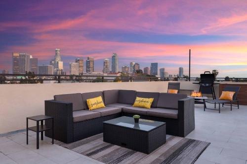 a couch on a rooftop with a view of a city at Spectacular Rooftop View House in Los Angeles