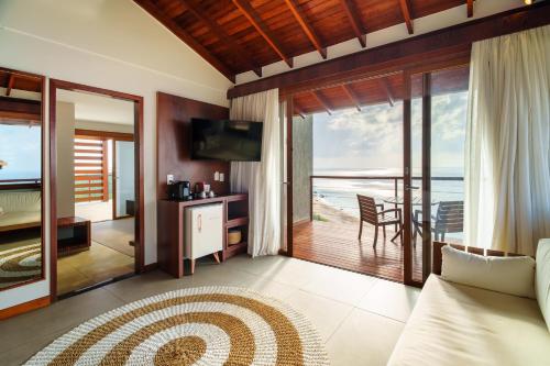 a bedroom with a bed and a view of the ocean at Pousada Ecológica Akanã in Fernando de Noronha