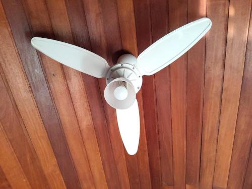 a ceiling fan hanging on a wooden wall at Casa em Botafogo (Rio de Janeiro) in Rio de Janeiro