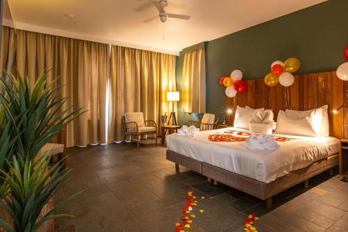a bedroom with a bed with balloons on it at Bayside Boutique Hotel - Blue Bay Golf & Beach Resort in Willemstad