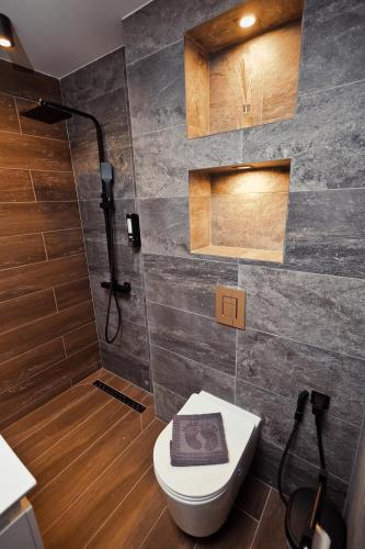 a bathroom with a toilet and a shower at AGIA- luxury apartment Sofia in Sofia