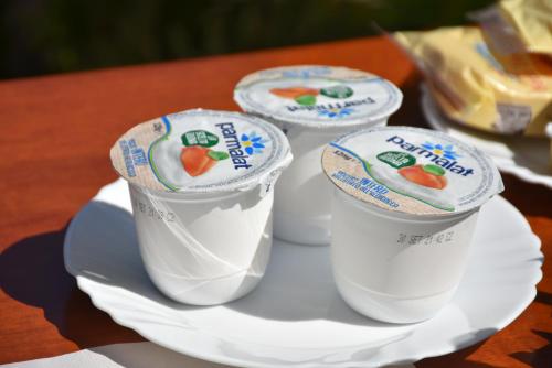 three styrofoam cups on a plate on a table at Hotel Villa del Sole in Porto Cesareo