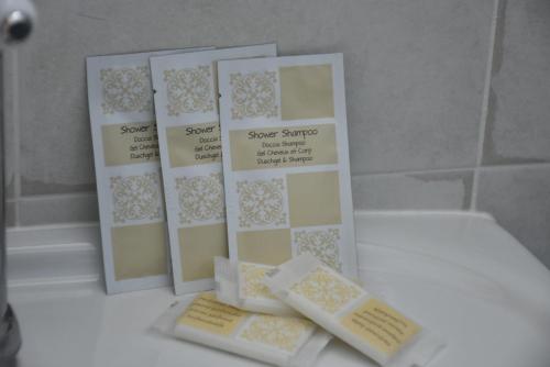 a group of four cards sitting on a bathroom counter at Hotel Villa del Sole in Porto Cesareo