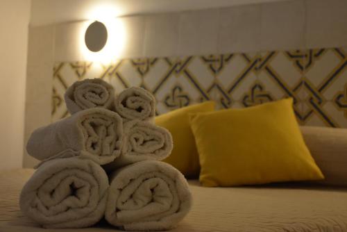 a pile of towels sitting on top of a bed at Hotel Villa del Sole in Porto Cesareo