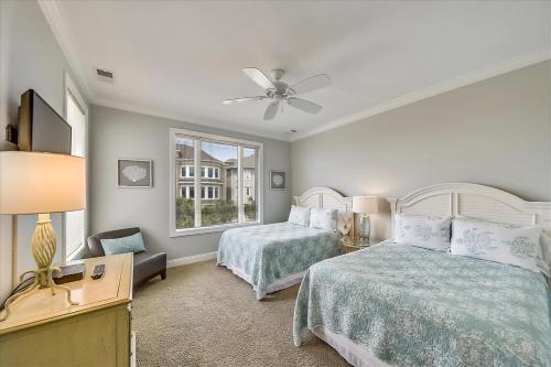 a bedroom with two beds and a ceiling fan at 6 Collier Beach Road- Oceanfront, Large Pool, Elevator, FREE Activities Included in Hilton Head Island