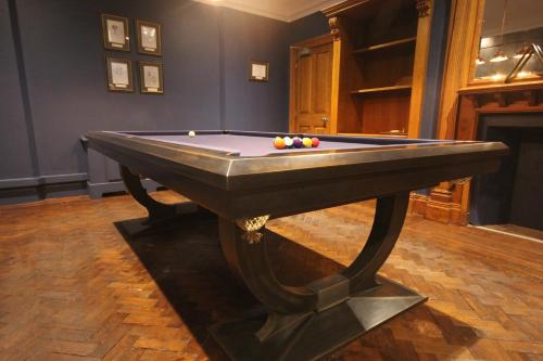 a pool table with balls on top of it at The Wood Norton in Evesham