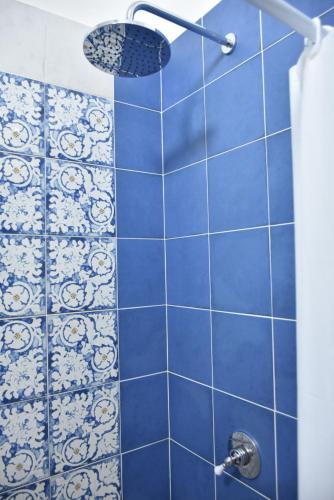 a blue tiled shower with a shower head at Hotel Villa del Sole in Porto Cesareo
