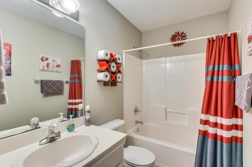 a bathroom with a sink and a toilet and a tub at 5 Mi to University of Oklahoma Home with Patio! in Norman
