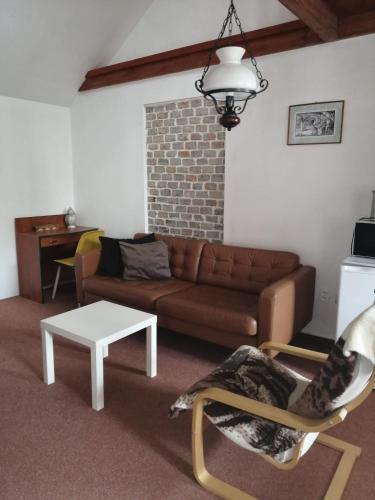 a living room with a couch and a table at Apartman Reduta in Lučenec