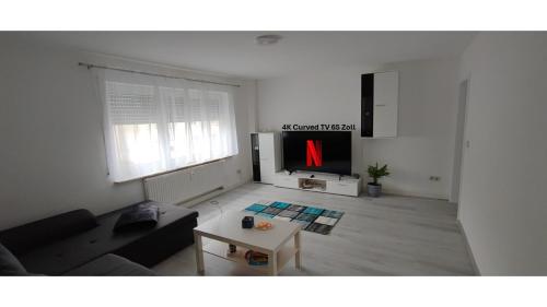 a living room with a tv with a red x on it at Blu Home/Ferienwohnung in Ostrach