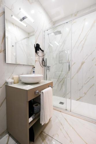 a bathroom with a sink and a shower at Napoli Class in Naples