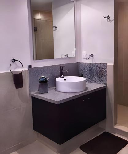 a bathroom with a white sink and a mirror at Exquisite Oceanfront Condo outstanding experience! in Puerto Vallarta