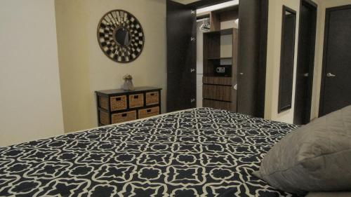 a bedroom with a bed and a clock on the wall at Exquisite Oceanfront Condo outstanding experience! in Puerto Vallarta