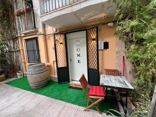 a front door of a house with a red chair and a barrel at 50 Brooklyn suite in Taranto