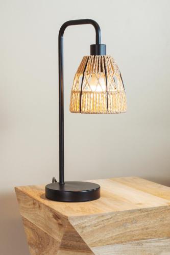 a lamp sitting on top of a wooden table at Gîte La Parenthèse pour 2 avec SPA et SAUNA Privatif in Saint-Fargeau