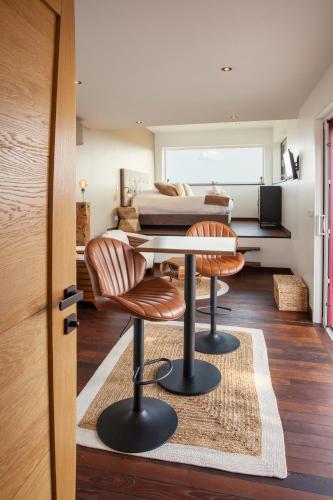a room with a table and two chairs and a bed at Gîte La Parenthèse pour 2 avec SPA et SAUNA Privatif in Saint-Fargeau
