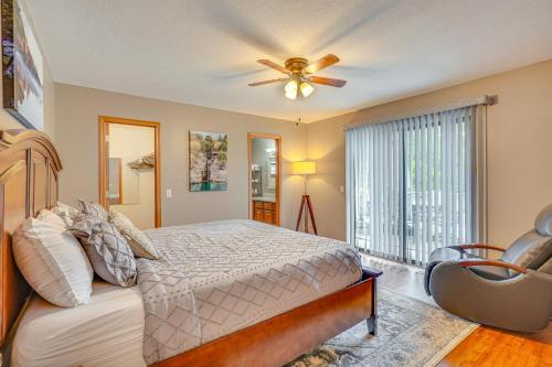 a bedroom with a bed and a ceiling fan at Near Dtwn Eureka Springs Holiday Island Home! in Holiday Island