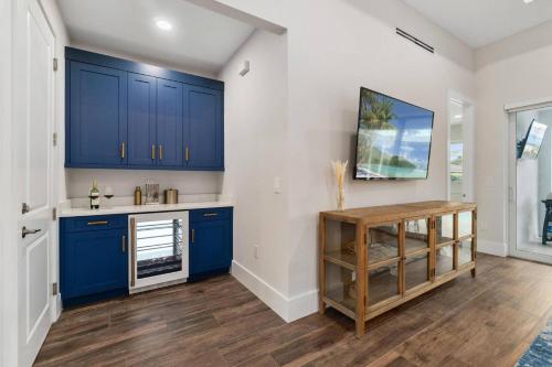a kitchen with blue cabinets and a wooden table at Deja Blu in Marco Island
