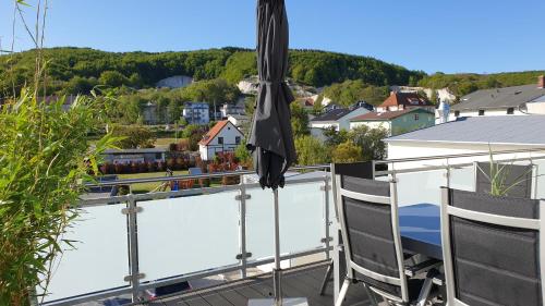 a view from the balcony of a house with an umbrella at Urlaubsdomizil InselLust-Rügen in Sassnitz
