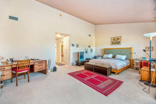 a large bedroom with a bed and a desk and a desk at House on the canal in Venice in Los Angeles