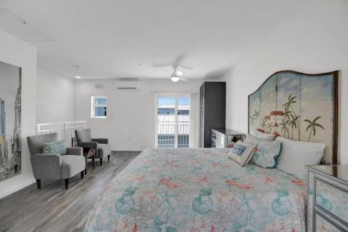 a large bedroom with a large bed and a chair at Ocean Breeze Gated Community in Marathon