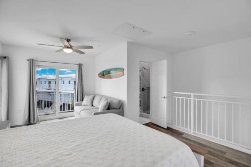 a white bedroom with a bed and a couch at Ocean Isles Seaside Oasis in Marathon