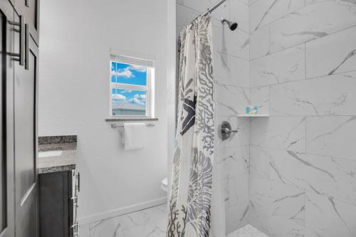 a bathroom with a shower with a shower curtain at Ocean Isles Seaside Oasis in Marathon