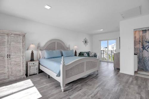 a bedroom with a large bed with blue pillows at Gated Oceanfront Heated Pool in Marathon