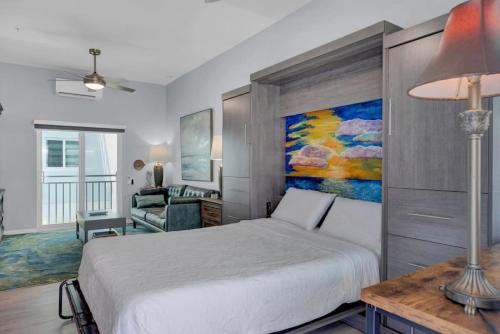 a bedroom with a bed and a painting on the wall at Oceanside Spacious Studio Escape in Marathon