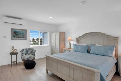 a bedroom with a large bed and a chair at Oceanfront Getaway in Marathon in Marathon