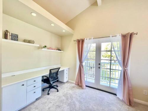 a home office with a desk and a window at New Charming Spacious Disneyland Pool Home in Garden Grove