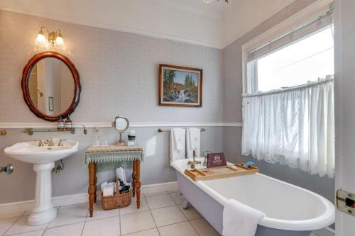 a bathroom with a tub and a sink at Romantic Victorian Getaway The Blue Room in Sutter Creek
