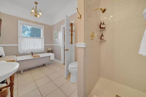 a bathroom with a tub and a toilet and a sink at Romantic Victorian Getaway The Blue Room in Sutter Creek