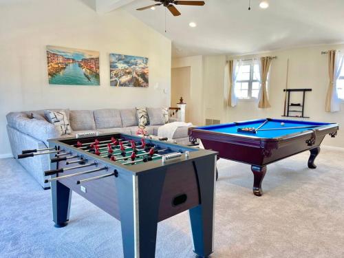 a living room with a pool table and a couch at New Charming Spacious Disneyland Pool Home in Garden Grove