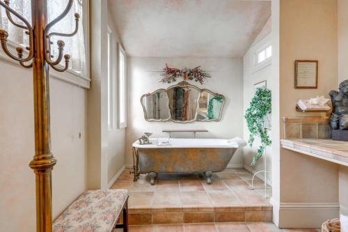 a bathroom with a tub and a mirror at Timeless Victorian Gem w Breathtaking Mountains in Sutter Creek