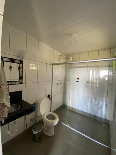 a bathroom with a toilet and a sink at Chalés Lavras de Minas - Brasil in Lavras Novas
