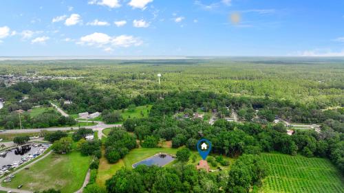 an aerial view of a park with a lake at Astor Manor At Rivers Edge in Astor